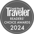 The logo for the Cond&eacute; Nast Traveler Readers' Choice Awards 2024 emblazoned over a gray circle with a white interior border. logo on footer section.